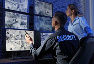 Security guards monitoring modern CCTV cameras